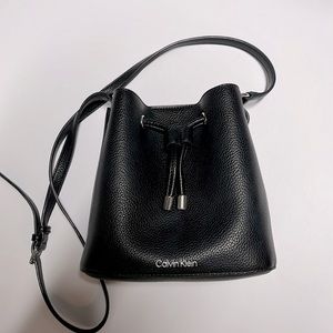 Calvin Klein,  Black Vegan Leather Pebblegrain   Crossbody with tan liner.